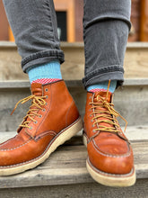 Red and light blue color block wool socks paired with Red Wing boots and black jeans