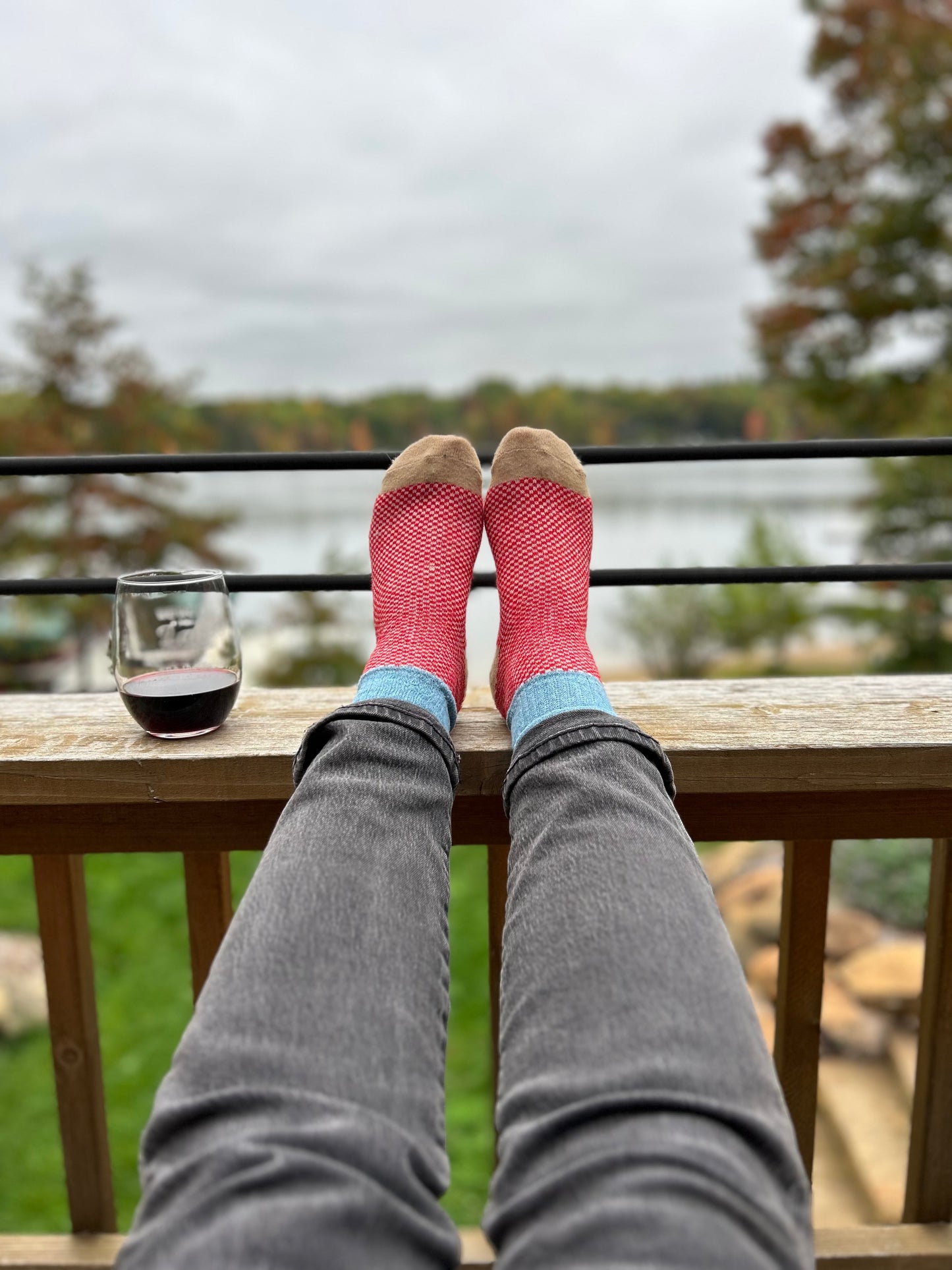Red and light blue color block wool socks paired with black jeans