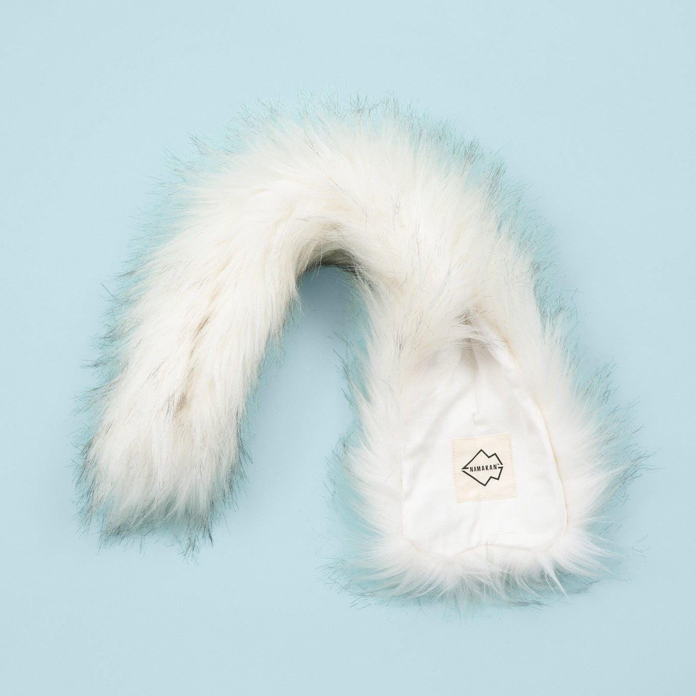 White fur collar on a light blue background