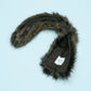 Faux fur hood trim with a logo on a light blue background