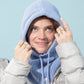 Person wearing a light blue knitted hood and scarf against a light blue background